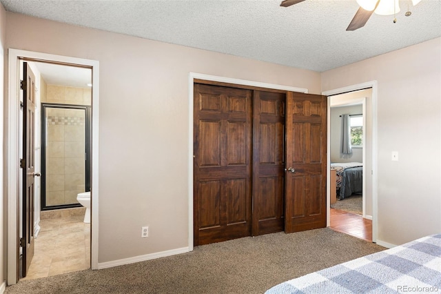 16225 W 74th Dr, Arvada, CO 80007 - unfurnished bedroom featuring light colored carpet, a closet, connected bathroom, baseboards, and a textured ceiling