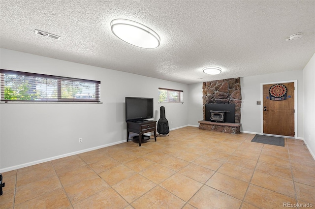 16225 W 74th Dr, Arvada, CO 80007 - living area featuring light tile patterned floors, a textured ceiling, and baseboards