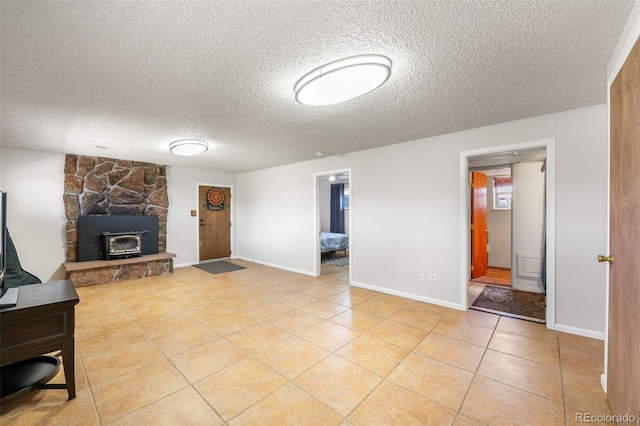 16225 W 74th Dr, Arvada, CO 80007 - unfurnished living room featuring a textured ceiling, light tile patterned flooring, and baseboards