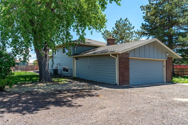 16225 W 74th Dr, Arvada, CO 80007 - view of property exterior featuring a chimney, roof with shingles, central AC, and brick siding