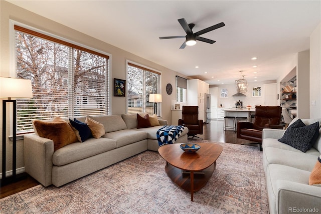 living room featuring wood finished floors, a ceiling fan, and recessed lighting