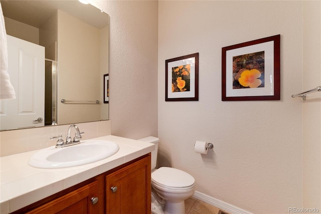 full bathroom with tile patterned flooring, baseboards, vanity, and toilet