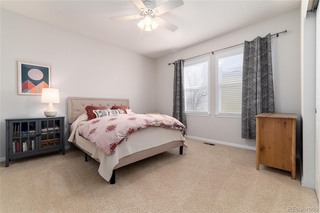 bedroom featuring ceiling fan, carpet floors, visible vents, and baseboards