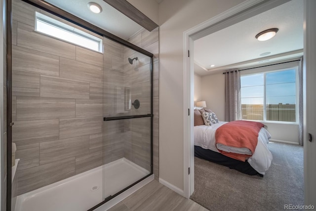 bathroom with a shower with door