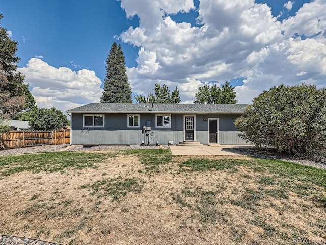 rear view of house with a lawn