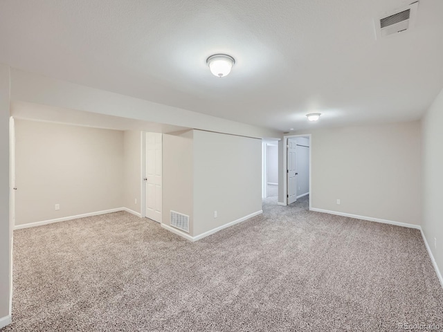 basement featuring light carpet