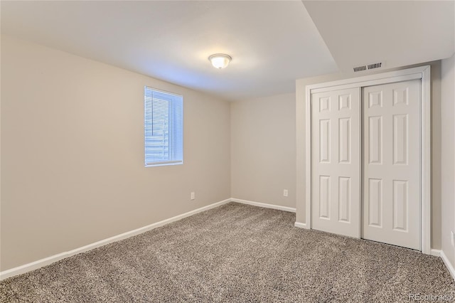 unfurnished bedroom with a closet and carpet flooring