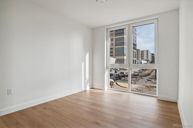 spare room with light hardwood / wood-style floors