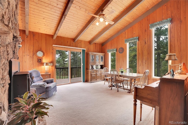 carpeted office space with wood walls, ceiling fan, wood ceiling, and vaulted ceiling with beams