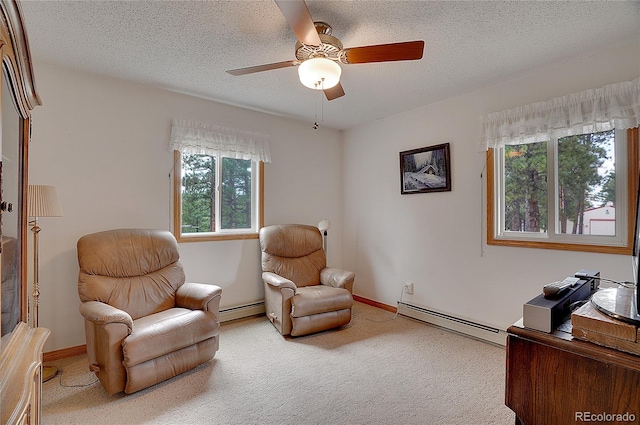 sitting room with a baseboard radiator, carpet floors, a textured ceiling, and ceiling fan