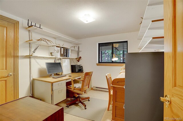 office area with a textured ceiling, baseboard heating, and light colored carpet