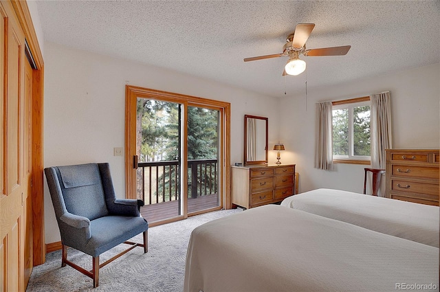 carpeted bedroom featuring a textured ceiling, access to exterior, ceiling fan, and a closet