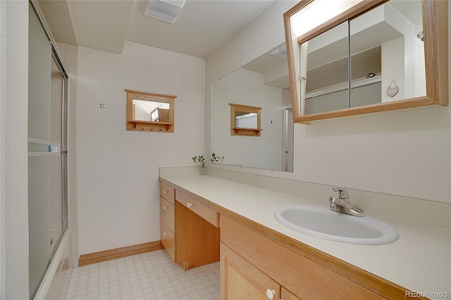 bathroom featuring shower / bath combination with glass door and vanity