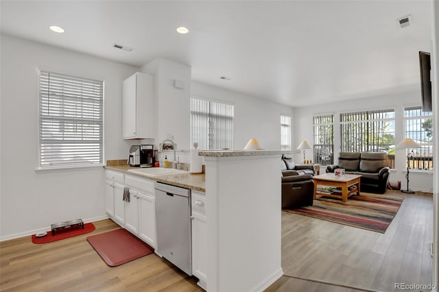 kitchen featuring stainless steel dishwasher, light hardwood / wood-style floors, white cabinets, and sink