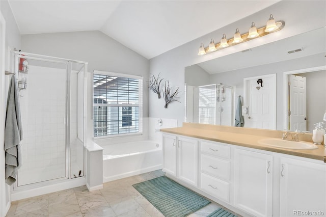 bathroom with vanity, shower with separate bathtub, and vaulted ceiling