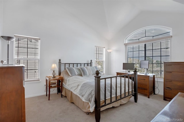 carpeted bedroom featuring high vaulted ceiling