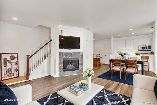 living room featuring a fireplace and light hardwood / wood-style floors