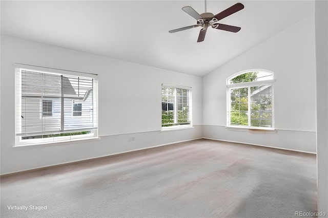 carpeted empty room featuring vaulted ceiling, a ceiling fan, and baseboards