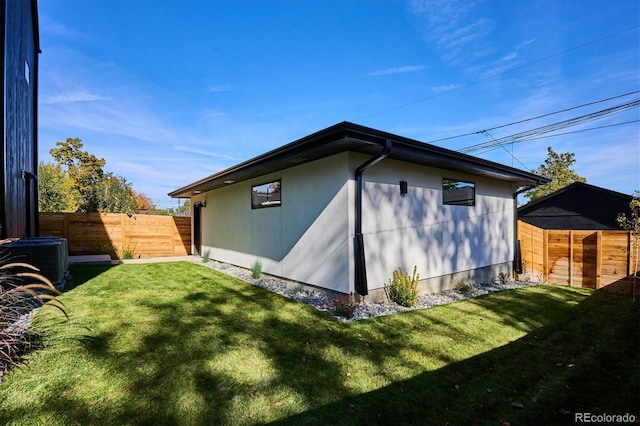 view of property exterior featuring a lawn and cooling unit