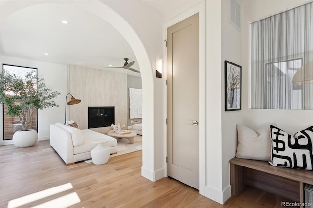 living room with ceiling fan and light hardwood / wood-style floors