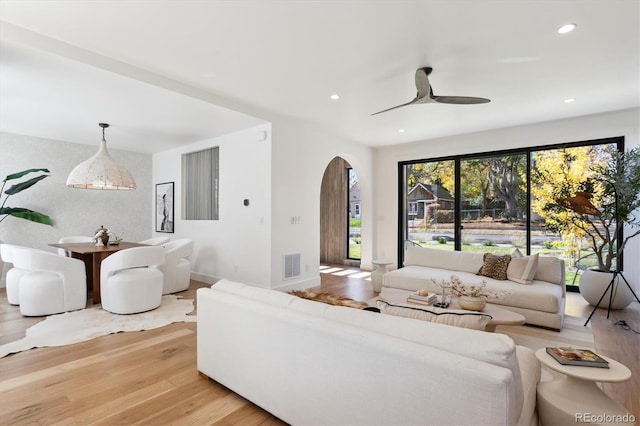 living room featuring hardwood / wood-style flooring and ceiling fan