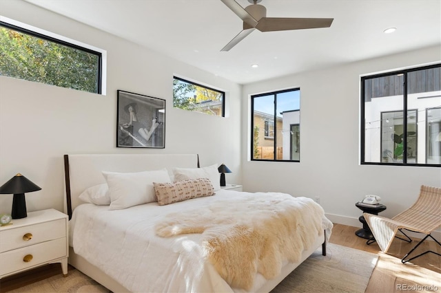 bedroom with light hardwood / wood-style floors and ceiling fan