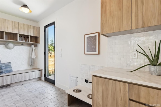 bathroom with tile patterned floors and decorative backsplash