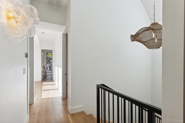 hallway with light hardwood / wood-style floors