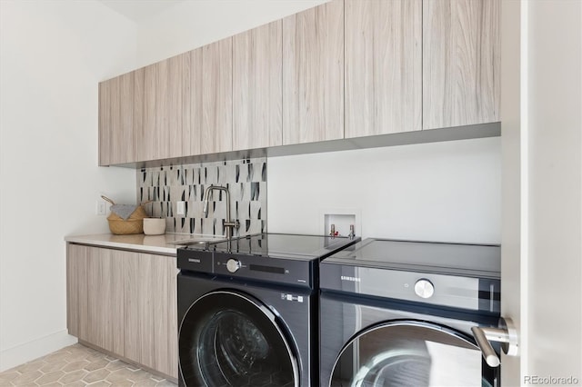 washroom with washer and dryer, light tile patterned floors, and sink