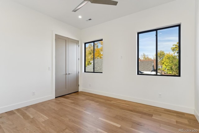 unfurnished bedroom with ceiling fan and light hardwood / wood-style flooring