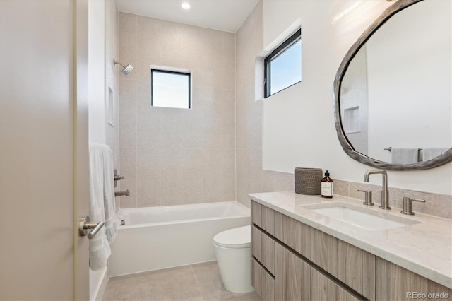 full bathroom with vanity, tile patterned floors, tiled shower / bath combo, and toilet