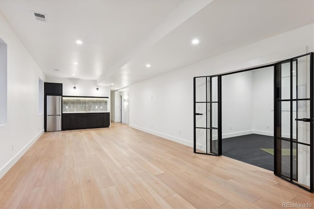 unfurnished living room with light wood-type flooring