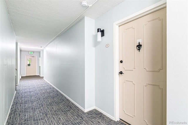 725 S Alton Way Unit 9C, Denver, CO 80247 - hallway with dark colored carpet and a textured ceiling