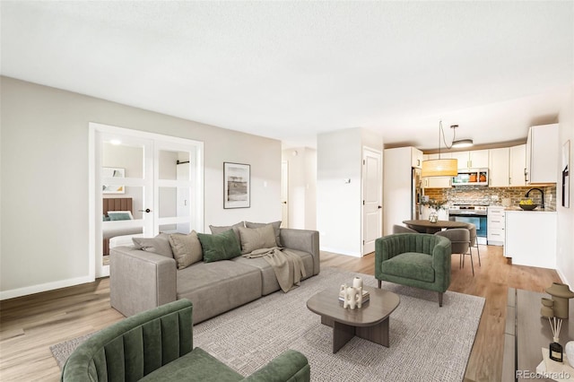 725 S Alton Way Unit 9C, Denver, CO 80247 - living room featuring light wood-style floors