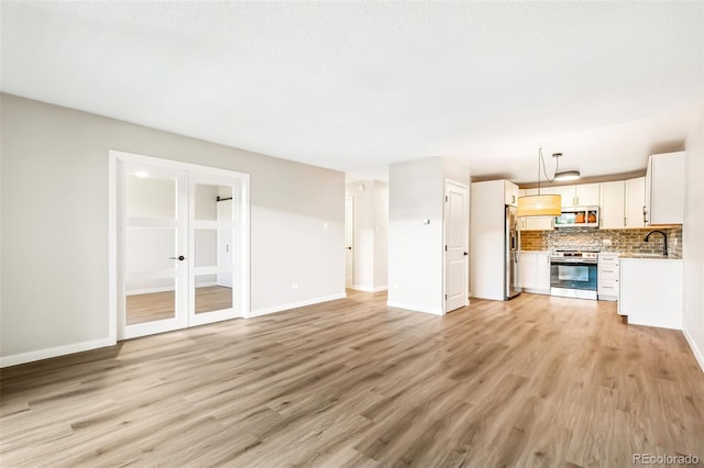 725 S Alton Way Unit 9C, Denver, CO 80247 - unfurnished living room with light wood-type flooring and french doors
