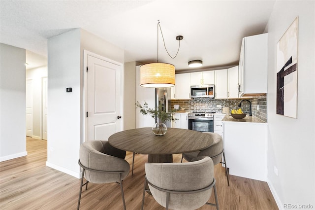 725 S Alton Way Unit 9C, Denver, CO 80247 - dining space with baseboards and light wood-style floors