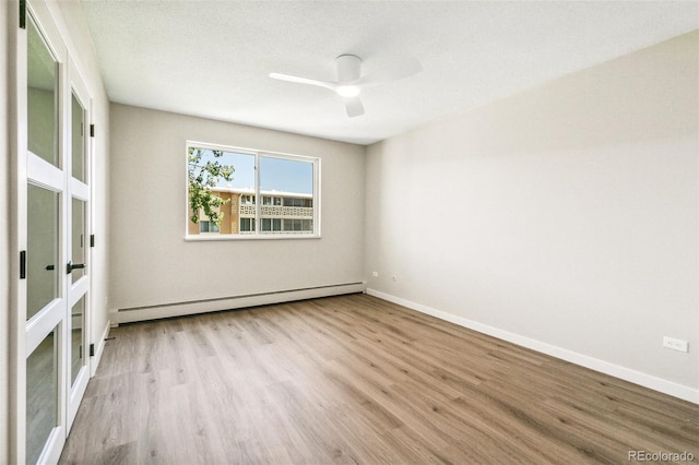 725 S Alton Way Unit 9C, Denver, CO 80247 - empty room featuring baseboard heating, wood finished floors, and ceiling fan