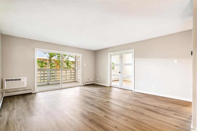 725 S Alton Way Unit 9C, Denver, CO 80247 - spare room featuring wood finished floors, a wall mounted air conditioner, and a baseboard heating unit