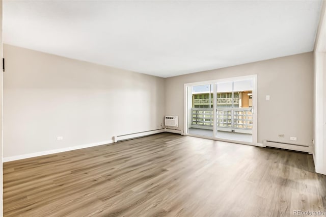 725 S Alton Way Unit 9C, Denver, CO 80247 - unfurnished room featuring a baseboard radiator and wood finished floors