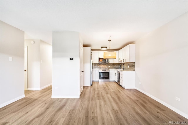 725 S Alton Way Unit 9C, Denver, CO 80247 - kitchen featuring appliances with stainless steel finishes, light wood finished floors, backsplash, white cabinets, and light countertops