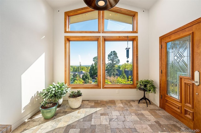 unfurnished sunroom featuring vaulted ceiling