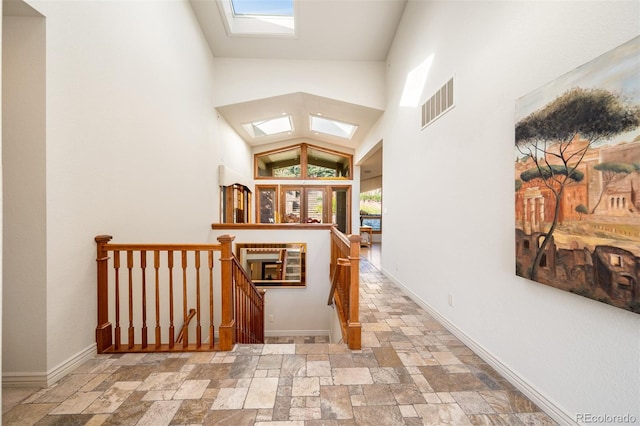 corridor featuring lofted ceiling with skylight