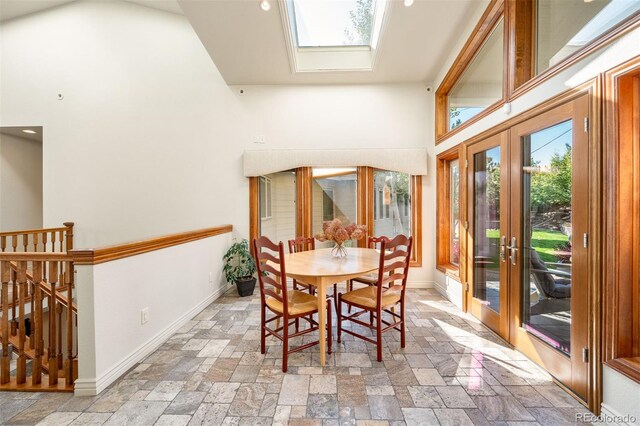 dining room featuring french doors and a skylight