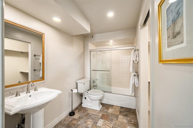 full bathroom with toilet, combined bath / shower with glass door, and sink