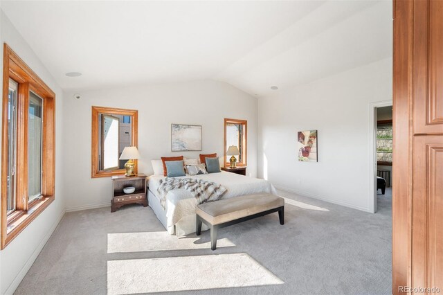 bedroom featuring light carpet and lofted ceiling