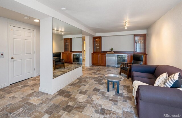 living room with wine cooler and track lighting