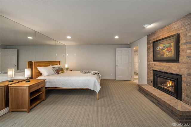 bedroom featuring light carpet, a textured ceiling, and a fireplace