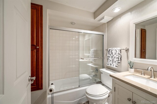 full bathroom featuring toilet, enclosed tub / shower combo, and vanity