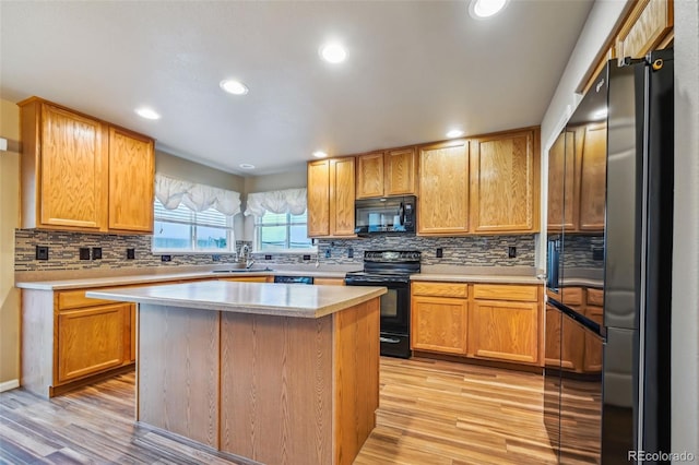 7625 Blue Vail Way, Colorado Springs, CO 80922 - kitchen featuring black appliances, light countertops, light wood finished floors, tasteful backsplash, and recessed lighting