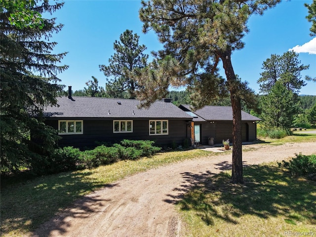 29858 Gigi Dr, Evergreen, CO 80439 - ranch-style house featuring driveway, a garage, and a front lawn
